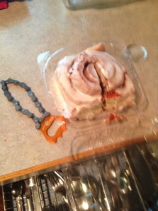 A Breadsmith cinnamon roll sits next to the bike sprocket beer top opener on the kitchen shelf. No, I didn't drink beer with cinnamon rolls. But I might have to try that. 