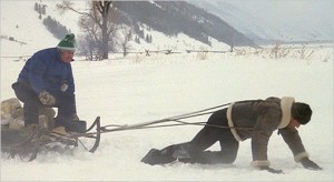 Lance Armstrong trains in the high Rockies pulling a sled with Chris Carmichael on board. 