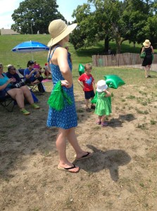 A young mother awaits for "dad" to come by in the first lap of the 13.1 mile run