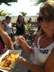 One triathlete who is not competing this day decides a chili cheese dog is a good breakfast