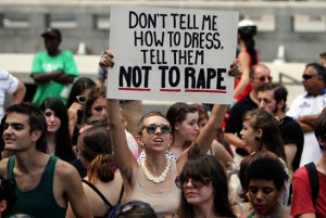 A participant holds up a sign during the Slut Walk demonstration in Philadelphia, on Saturday, Aug. 6, 2011. Organizers of the walks aim to raise awareness for womenís issues including the fact that no woman asks to be raped because of her style of dress. (AP Photo/Joseph Kaczmarek)