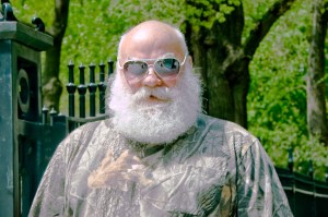 White guy with beard and glasses and camo